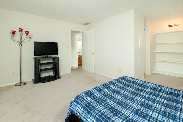 bedroom with carpet floors and a textured ceiling