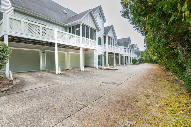 exterior space with a garage and a sunroom