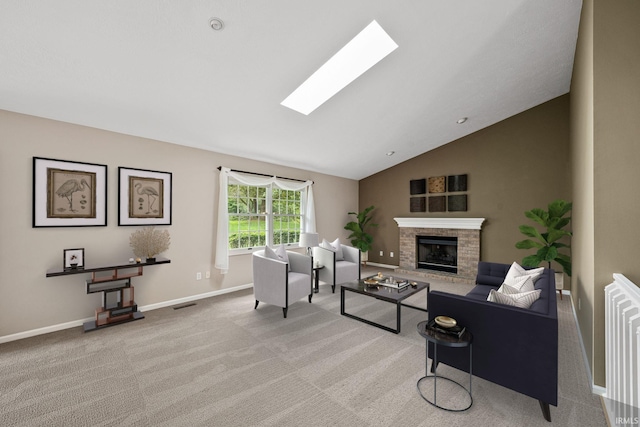 carpeted living room featuring a brick fireplace and lofted ceiling