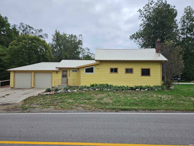 ranch-style home with a garage and a front yard