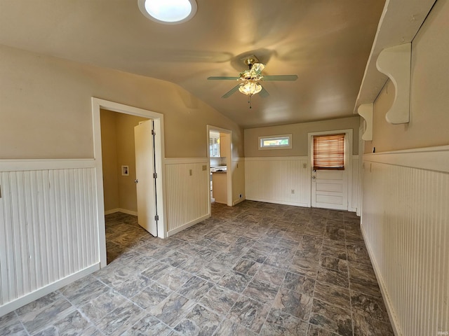 spare room with vaulted ceiling and ceiling fan