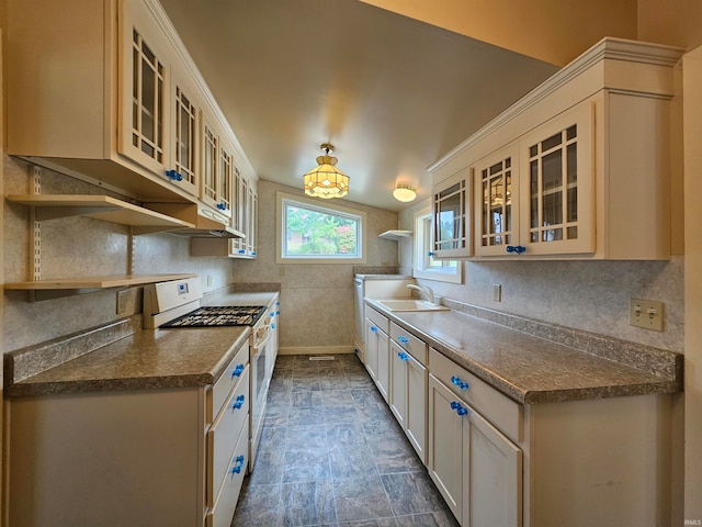 kitchen featuring white range with gas stovetop and sink