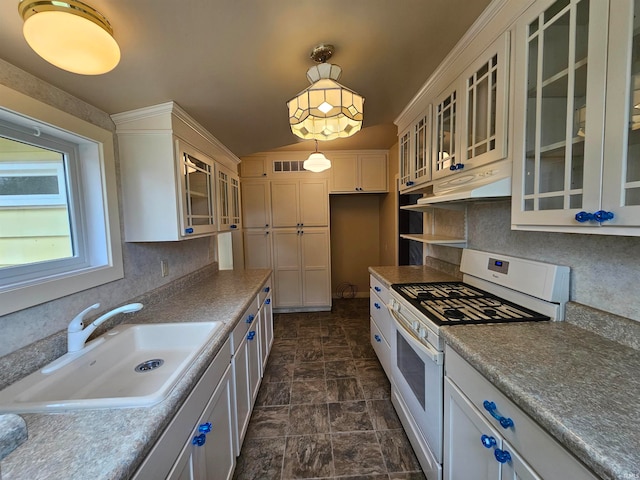 kitchen with white cabinetry, decorative light fixtures, white range with gas cooktop, and sink