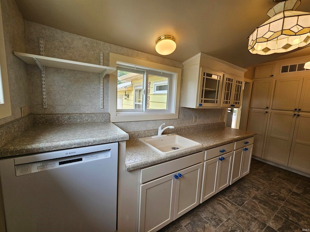 kitchen with dishwasher, white cabinetry, decorative light fixtures, and sink