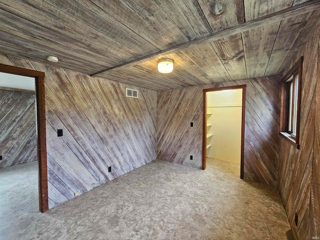 additional living space featuring wood walls