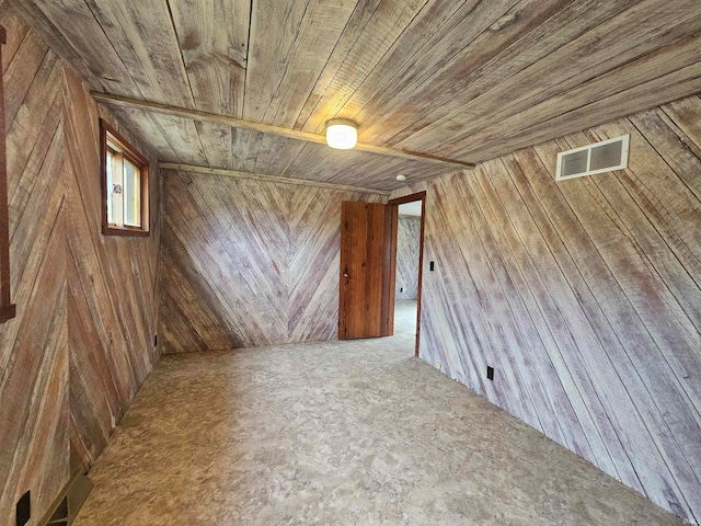 basement featuring wooden walls and wood ceiling