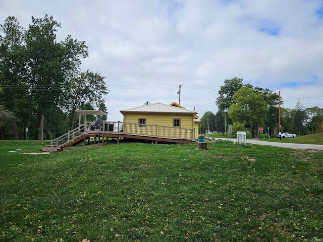 exterior space with a wooden deck and a lawn