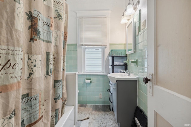 bathroom featuring shower / bath combination with curtain, tile walls, and vanity