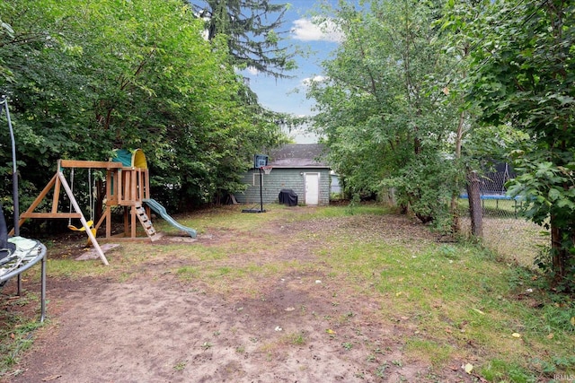 view of yard featuring a storage shed and a playground