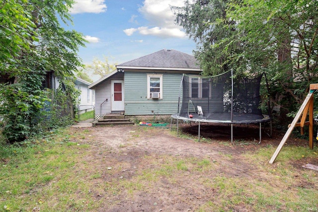 rear view of house with a trampoline and cooling unit