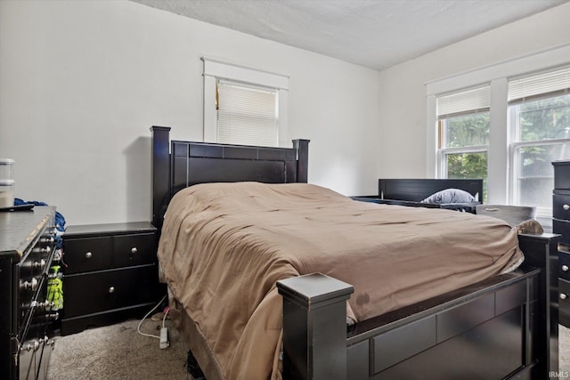 carpeted bedroom featuring a textured ceiling