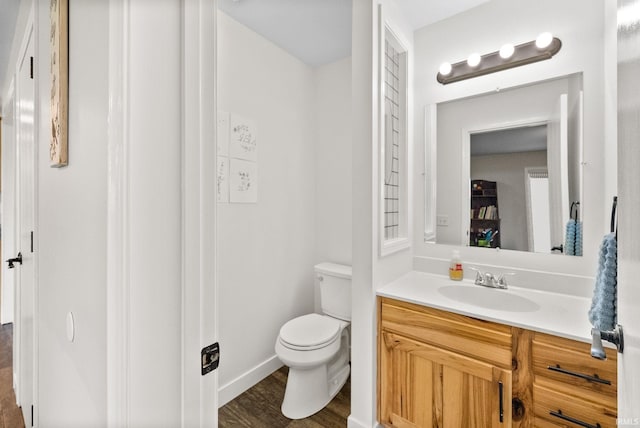 bathroom featuring hardwood / wood-style floors, vanity, and toilet