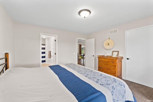 carpeted bedroom with ensuite bathroom