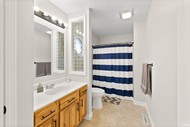 bathroom featuring curtained shower, vanity, toilet, and tile patterned floors