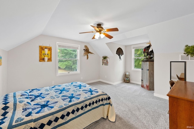 bedroom featuring light carpet, lofted ceiling, ceiling fan, and multiple windows