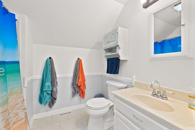 bathroom featuring vanity, lofted ceiling, toilet, and tile patterned floors