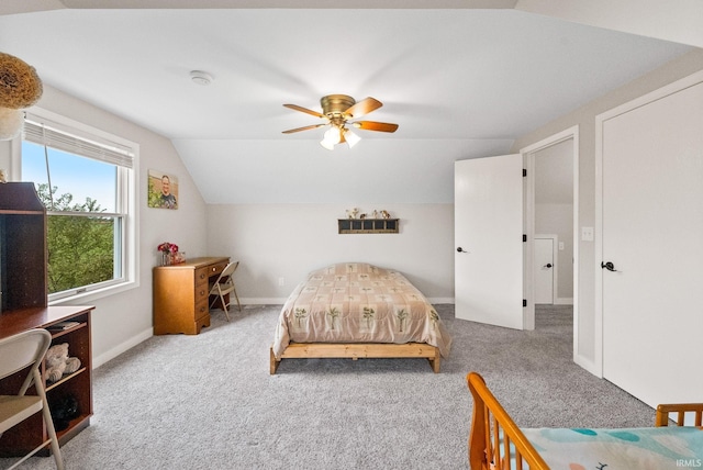 bedroom featuring ceiling fan, lofted ceiling, and carpet