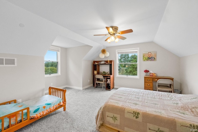 bedroom featuring multiple windows, lofted ceiling, ceiling fan, and light colored carpet