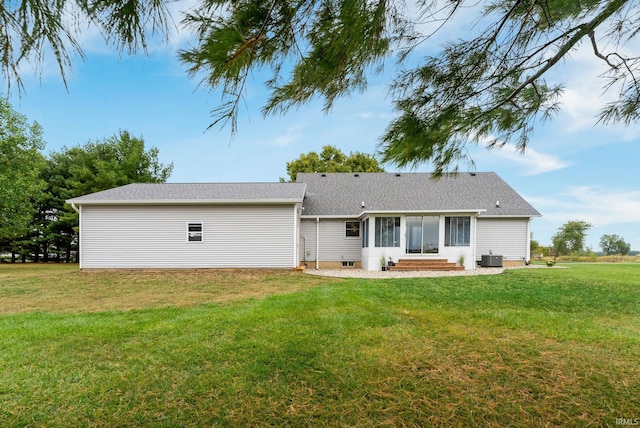 back of house with a yard and central air condition unit