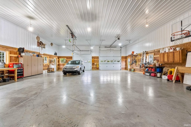 garage featuring a garage door opener and a workshop area