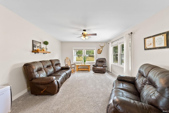 carpeted living room featuring ceiling fan