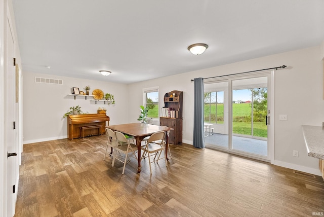 dining space with light hardwood / wood-style floors