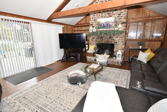 living room with wooden walls, lofted ceiling with beams, and dark hardwood / wood-style flooring