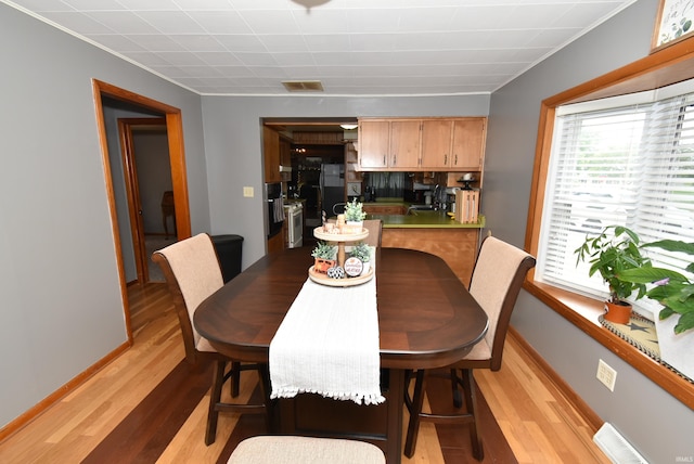 dining area with light hardwood / wood-style floors