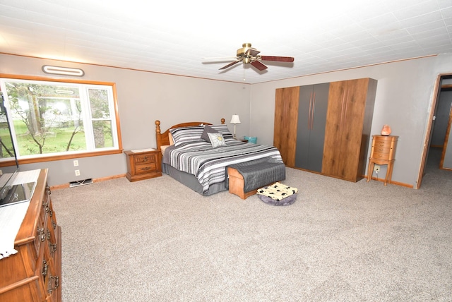 carpeted bedroom with ceiling fan