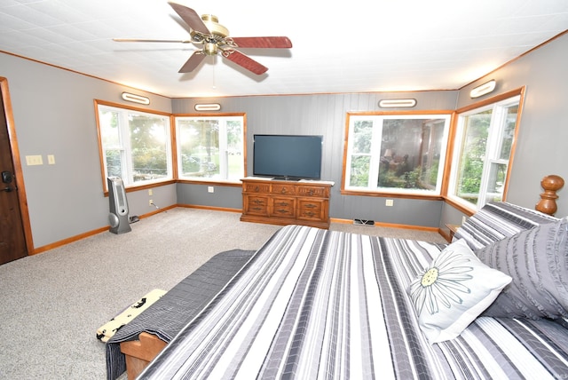 bedroom featuring crown molding, carpet flooring, and ceiling fan