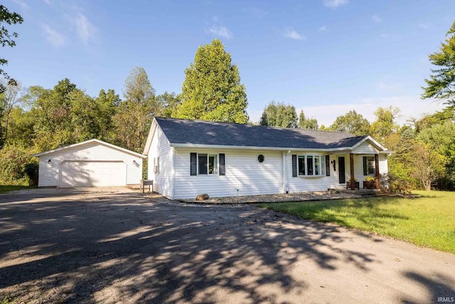 single story home featuring an outbuilding and a garage