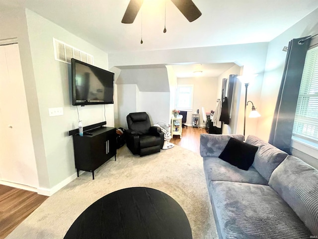 living room featuring ceiling fan and hardwood / wood-style floors