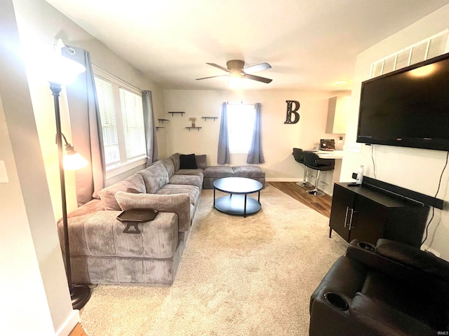 living room with ceiling fan and hardwood / wood-style flooring