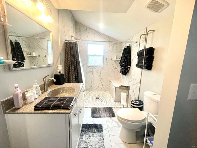 bathroom with lofted ceiling, toilet, vanity, and curtained shower