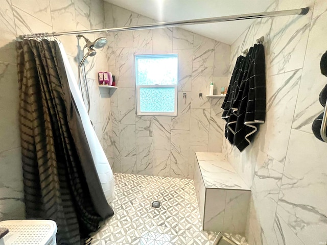 bathroom featuring walk in shower and tile walls