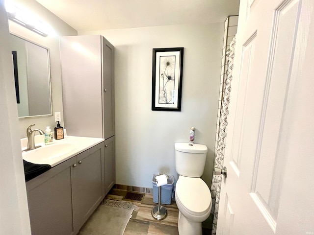 bathroom with vanity, hardwood / wood-style floors, and toilet