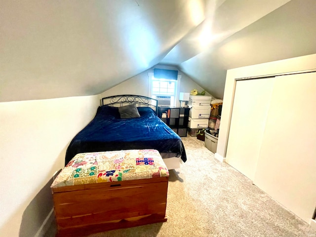 carpeted bedroom featuring a closet and vaulted ceiling