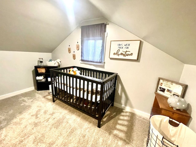 bedroom featuring carpet floors, a crib, and vaulted ceiling