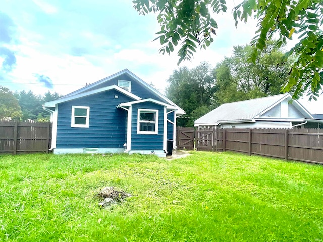 rear view of property featuring a yard