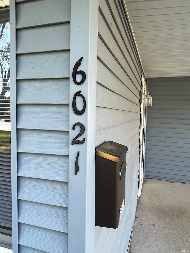 exterior details featuring concrete floors and wood walls