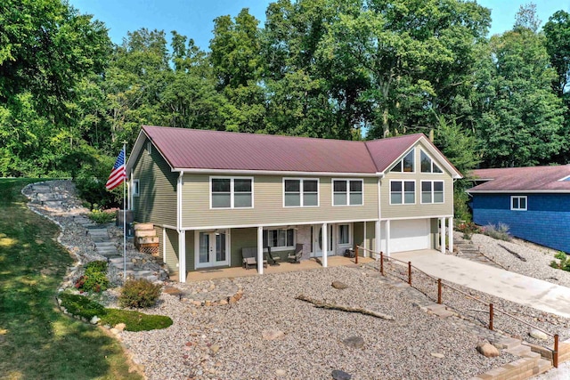 view of front of home with a garage and a patio area