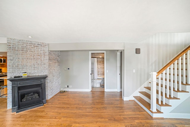 unfurnished living room featuring hardwood / wood-style flooring