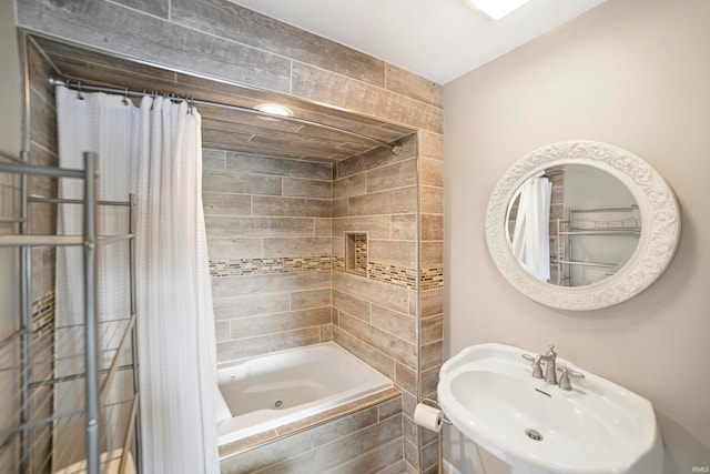 bathroom featuring sink and shower / tub combo with curtain