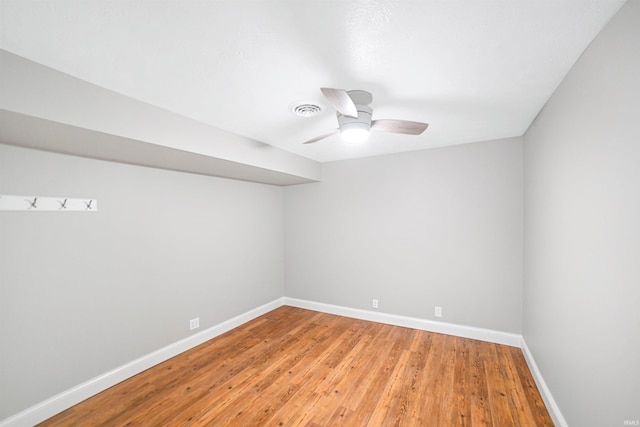 spare room with ceiling fan and hardwood / wood-style flooring