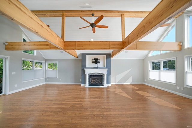 unfurnished living room with ceiling fan, hardwood / wood-style flooring, and high vaulted ceiling