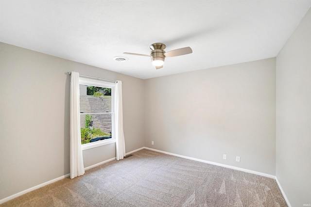 carpeted spare room with ceiling fan