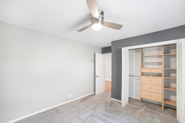 unfurnished bedroom featuring ceiling fan, carpet, and a closet