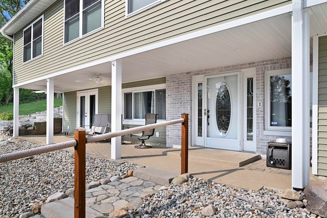 view of exterior entry with ceiling fan