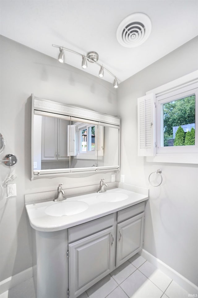 bathroom featuring tile patterned flooring and vanity