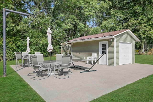 view of patio featuring an outbuilding and a garage